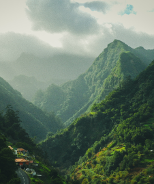 mesmerizing-scenery-green-mountains-with-cloudy-sky-surface 1