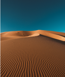 vertical-shot-peaceful-desert-clear-blue-sky-captured-morocco 1